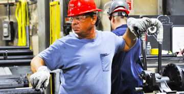 Two pipe workers wearing safety gear